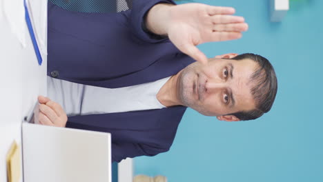 Vertical-video-of-Businessman-saying-stop-to-camera.